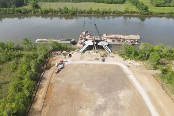 Aerial overview of the Ashland City River Port showing the completed barge dock and surrounding construction site