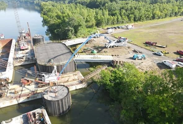 Wide aerial view of the completed concrete dock platform and bridge during Ashland City river port construction