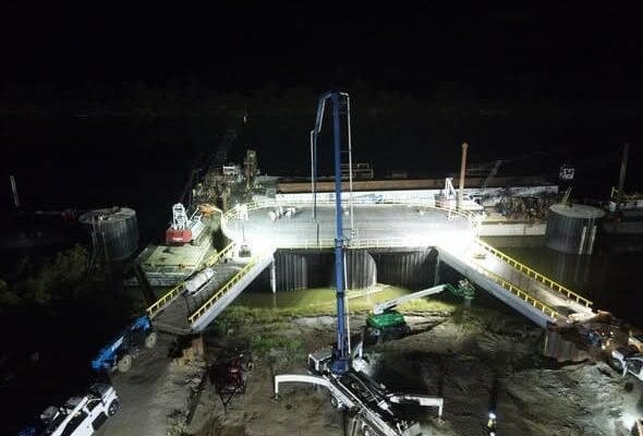 Concrete pump delivering marine concrete for barge dock construction on the Cumberland River in Tennessee