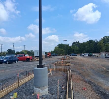 Commercial concrete curb installation around a parking lot light pole at the Sprouts Farmers Market project in Clarksville, TN