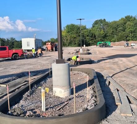 New curved concrete curb around a light pole during Sprouts Farmers Market construction in Clarksville, Tennessee