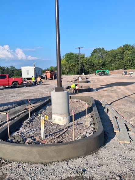 New curved concrete curb around a light pole during Sprouts Farmers Market construction in Clarksville, Tennessee